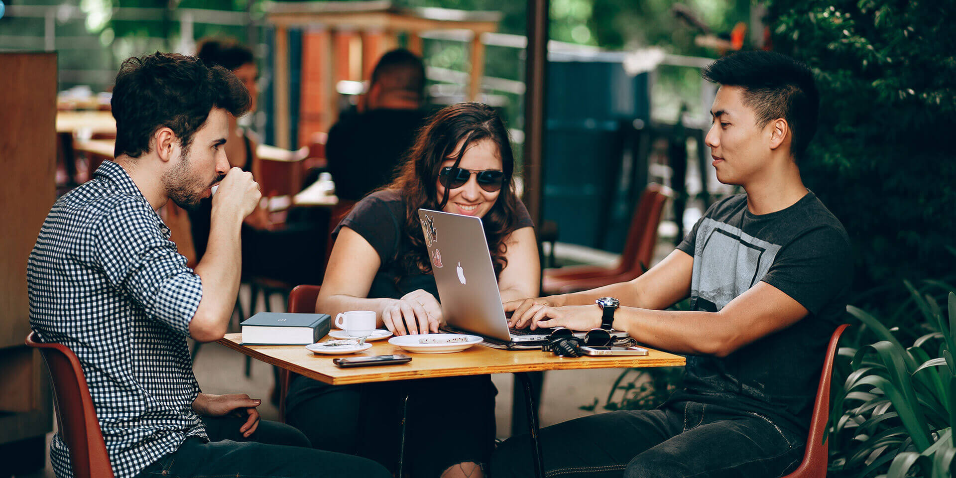 Three people at a table at a coffee shop